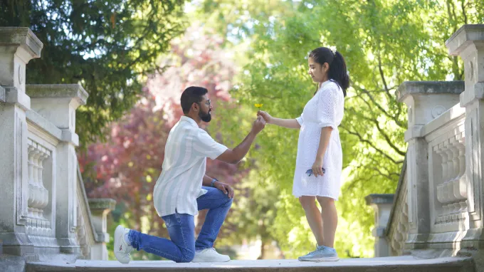 Arnab offering Bidisha a small flower in a garden